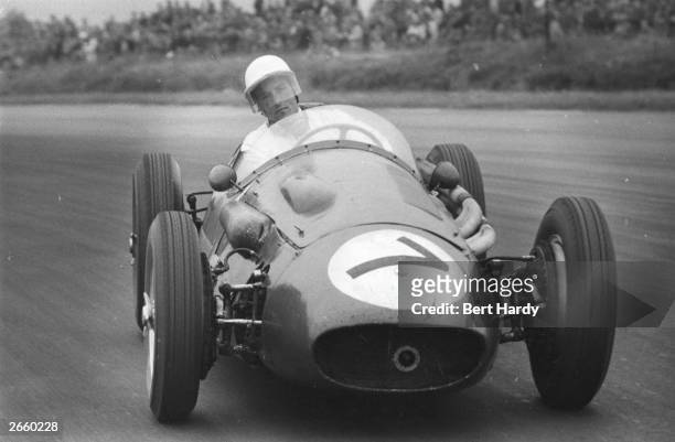 Racing driver Stirling Moss in action during the Silverstone Grand Prix. Original Publication: Picture Post - 8965 - Silverstone Grand Prix - 1956 -...