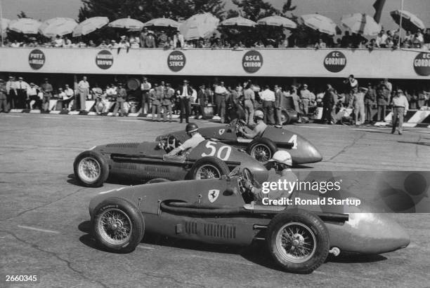 Three of the favourites, for the Monza Grand Prix, lining up for the start. They are No. 4 Alberto Ascari in a Ferrari, No. 50 Juan Manuel Fangio in...