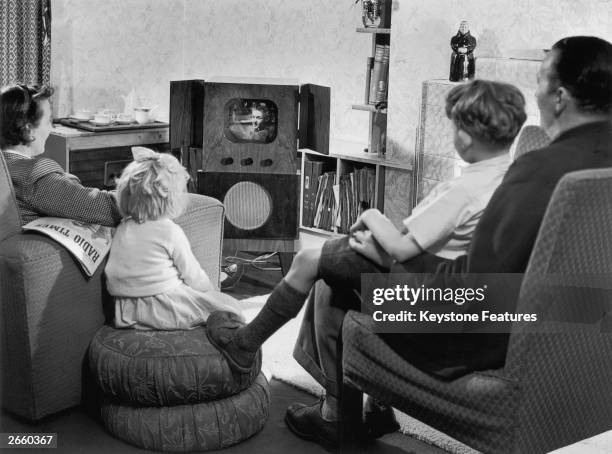 Family watching television in their home.