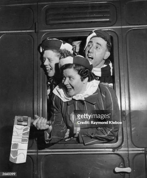 Tottenham Hotspur supporters shouting out of the window of the football 'Special' train, as it pulled out of Euston Station. Original Publication:...