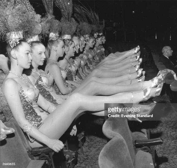 The long-legged Bluebell Girls, stars of the Royal Variety Performance at London's Palladium Theatre, relax in the stalls during rehearsals, London,...