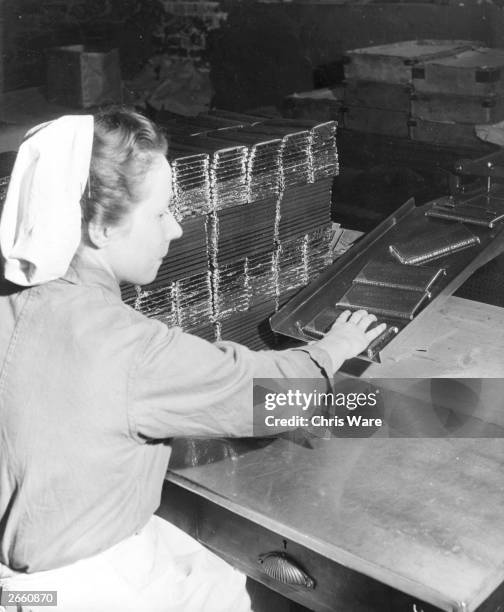 Factory worker packing bars of Ambrosia dessert chocolate in preparation for the lifting of the chocolate ration.