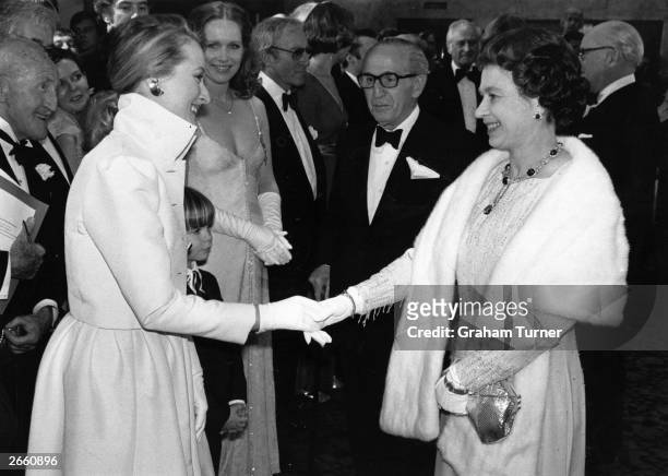 American actress, Meryl Streep meeting Queen Elizabeth II after a Royal Film Performance of 'Kramer vs Kramer' at the Odeon, Leicester Square,...