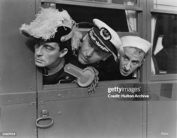 American comics Admiral Buster Keaton , Captain Lew Cody and rating Jimmy Durante looking out of Keaton's 'land yacht', which he used as a venue for...