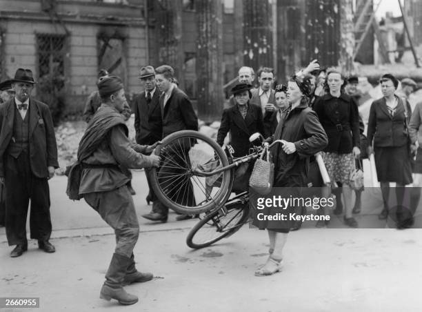 Russian soldier involved in a misunderstanding with a German woman in Berlin, over a bicycle he wished to buy from her.
