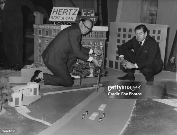 Cliff Michelmore pointing to the path of gun shots which killed President John F Kennedy, on a model reconstruction of the Dealey Plaza, Dallas, in...