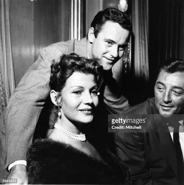 Rita Hayworth , Jack Lemmon and Robert Mitchum during the filming of Robert Parrish's 1957 film 'Fire Down Below', 26th July 1956.