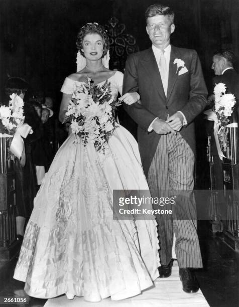 Senator John Fitzgerald Kennedy , Democratic senator for Massachusetts, escorts his bride Jacqueline Lee Bouvier down the church aisle shortly after...