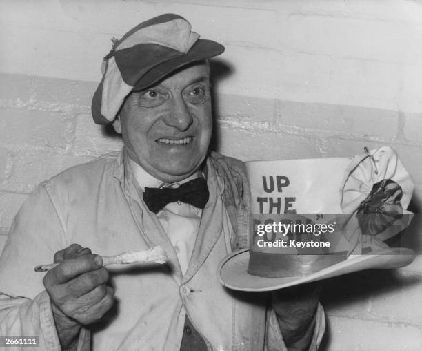 Peterborough United football club's mascot Dusty Hall, painting his hat with the slogan 'Up The Posh', in preparation for his team's fourth round cup...