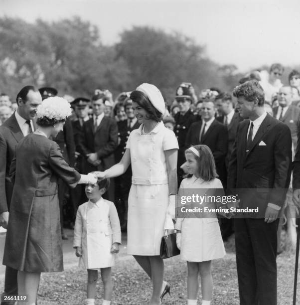 Jacqueline Kennedy , with her children, John Jr. And Caroline, and her brother-in-law Robert Kennedy greet the Queen, during a ceremony to unveil a...