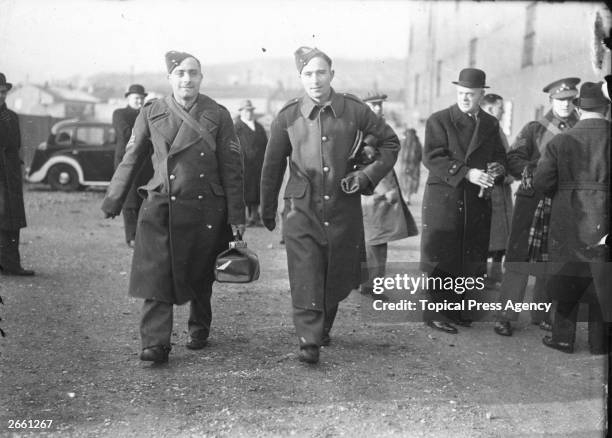 England and Arsenal footballers Sergeant Wilf Copping, left, and Gunner Denis Compton arrive in uniform at Selhurst Park to play for the Army team,...