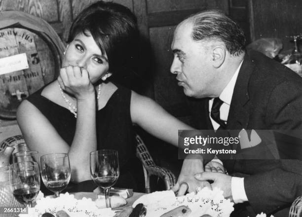 Italian film actress Sophia Loren in a restaurant in France with her husband Carlo Ponti, the man credited with discovering her.