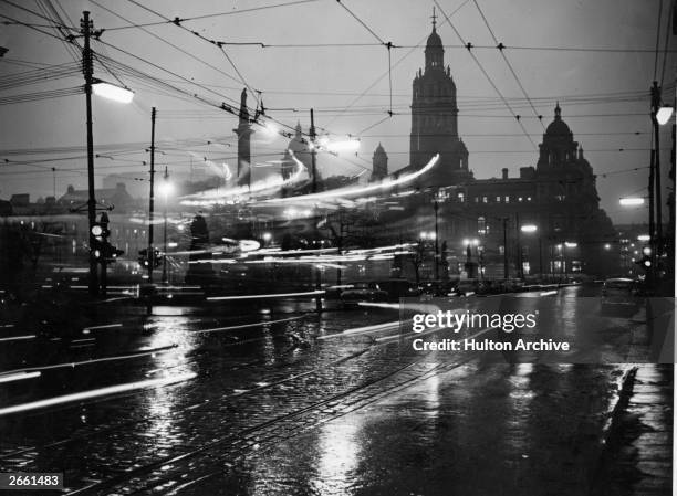 The lights of moving traffic streak past on a rainy night in Glasgow . Glasgow is the most densely populated city in Scotland and is an important...