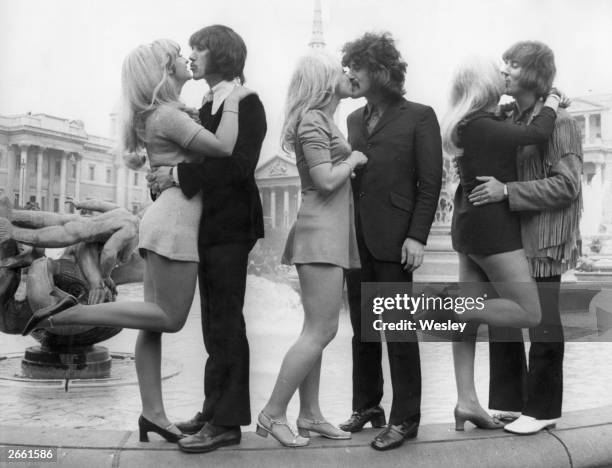 Three members of English pop group The Tremeloes; Chip Hawkes, Alan Blakley and Dave Munden, kissing their brides; Carol Dilworth, Lyn Stevens and...