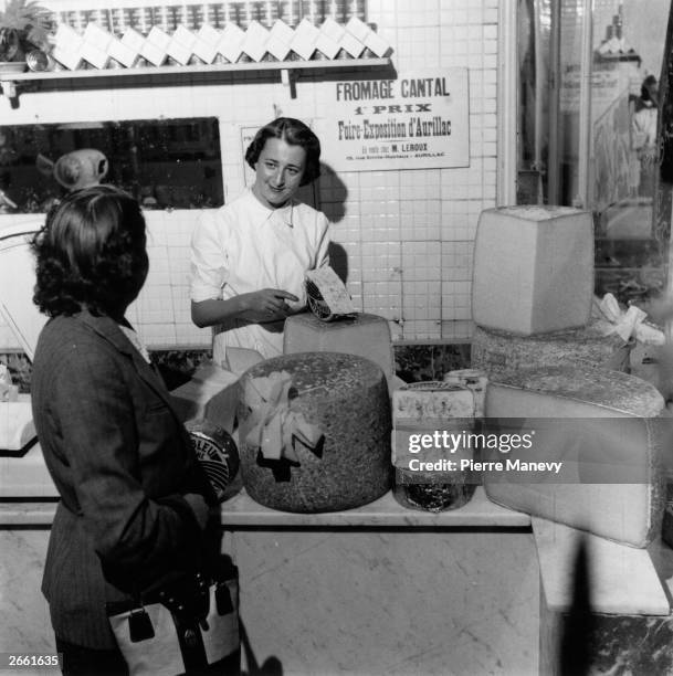 Woman buying cheese in France. Original Publication: Picture Post - 7282 - Why France Dithers - pub. 1954