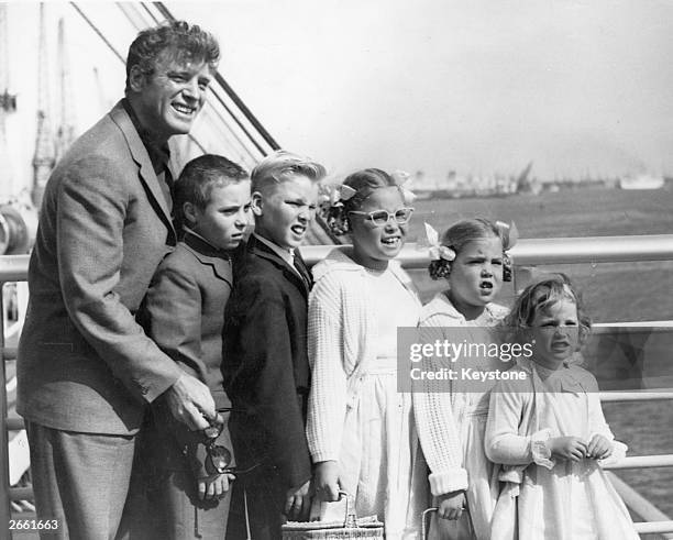 American actor Burt Lancaster with his five children as the liner brings them from the US docks in Southampton. He has come to Britain to film 'The...