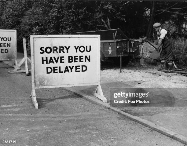 Road sign reading 'Sorry You Have Been Delayed', in England.