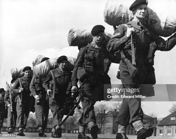 Members of the Devonshire regiment marching with their kitbags, during training for their posting in Kenya.