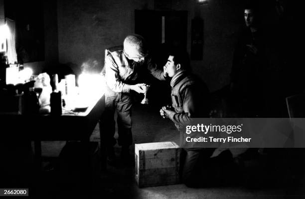 Marine chaplain Eli Tavesian giving communion to marine Louis A Loya, at Forward Command Post in Hue, Vietnam.