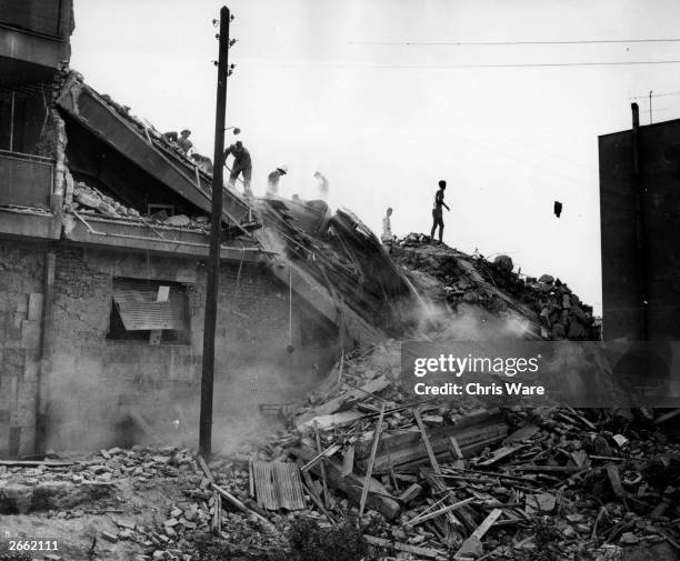 Troops and workers looking for survivors in the ruins left by the Skopje earthquake, Yugoslavia.