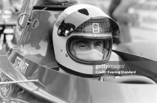 Scottish racing driver Jackie Stewart in his car before the British Grand Prix at Silverstone. Stewart, born in Dumbarton, raced Formula 1 cars...