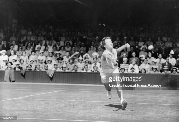 American tennis player Maureen Connolly in action against Miss Partridge at the Wimbledon Lawn Tennis Championships. Original Publication: People...