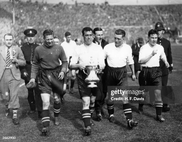 Everton captain Dixie Dean carry's the FA Cup trophy on a lap of honour around Wembley Stadium after his side's 3-0 victory over Manchester City in...