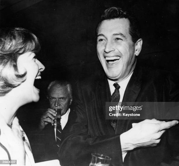 American actor Rock Hudson shares a joke with his latest date Marilyn Maxwell in Hollywood.