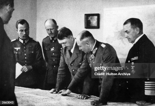 German dictator Adolf Hitler at his headquarters at Bruly-de-Peche, Ardennes, Belgium, during the campaign of May-June 1940. Left of Hitler is...