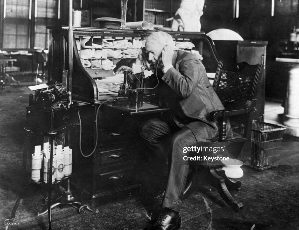 American inventor Thomas Edison dictating instructions to an employee ...