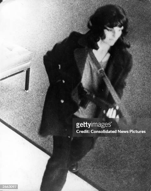 American heiress Patty Hearst is caught on surveillance camera during a bank robbery in San Francisco. She was kidnapped by the Symbionese Liberation...