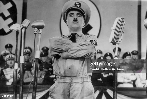 English actor Charlie Chaplin directs and stars in the film 'The Great Dictator'.