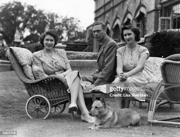 George VI , king of Great Britain, with his two daughters, Princess Elizabeth, left, and Princess Margaret Rose , at the Royal Lodge at Windsor.