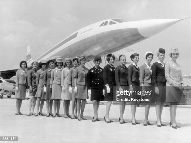 Line-up of some of the air stewardesses who attend to passengers on board 'Concorde', each one from a different airline. They are standing in front...