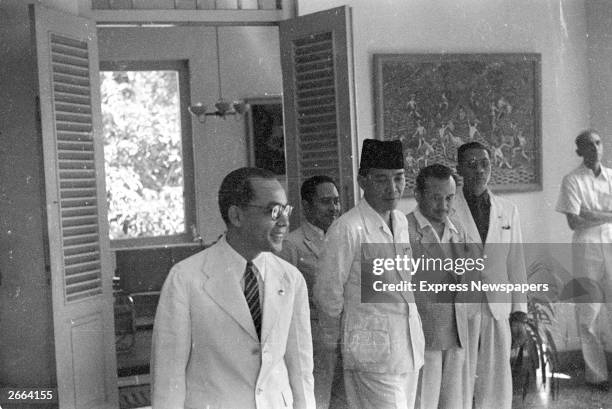 President of Achmad Sukarno of Indonesia, third from left, with members of his government. Sukarno became the first president of the new Indonesian...