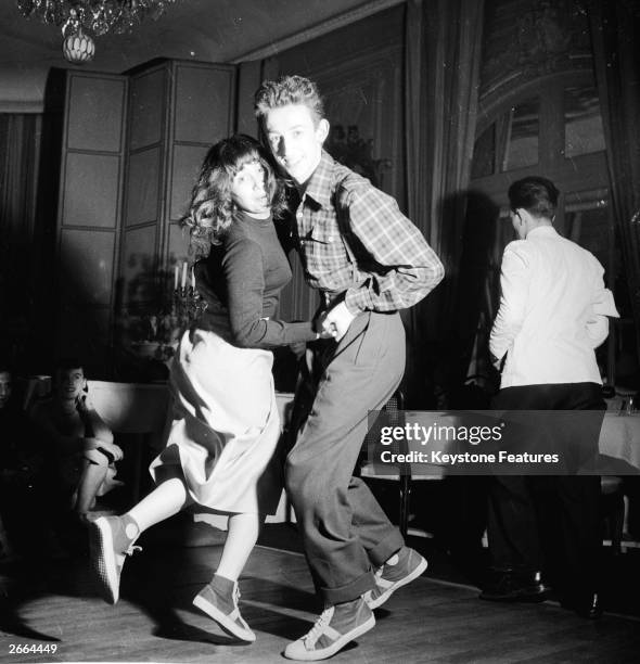 Baseball-booted students jitterbugging at the Carrere night club in Paris.