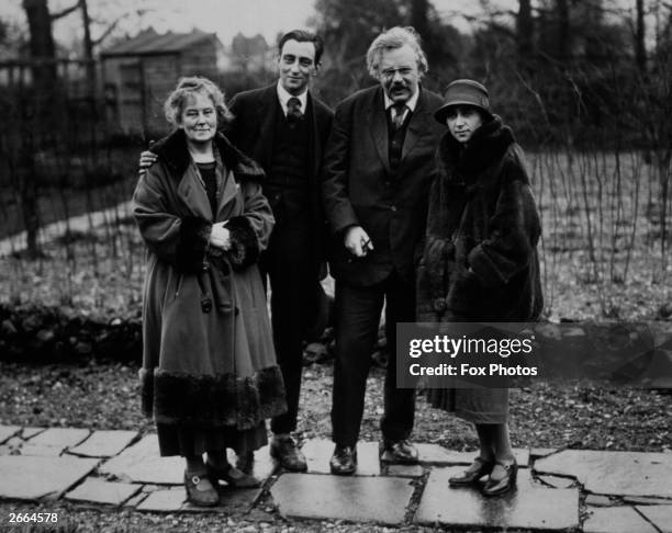 English author Gilbert Keith Chesterton in the garden of his home in Beaconsfield with his wife and children.
