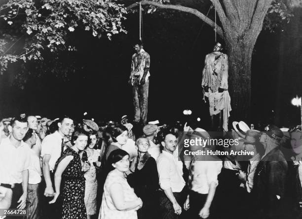 Crowd gathering to witness the killing of Thomas Shipp and Abram Smith, two victims of lynch law in Marion, Indiana, 7th August 1930. This image was...