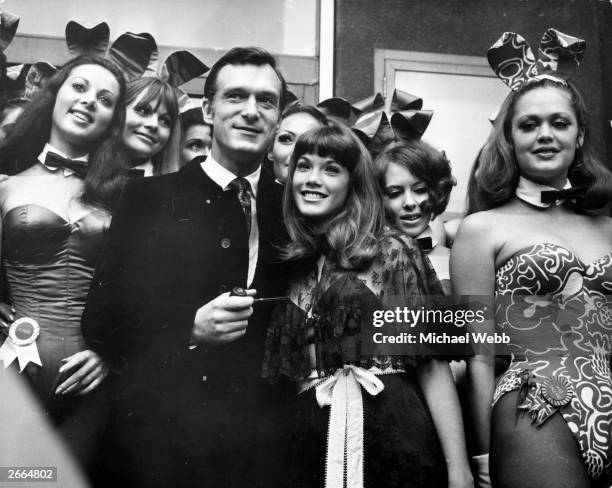 American pornography publisher and club entrepreneur, Hugh Hefner with American actress, Barbara Benton amongst English 'Bunny Girls' at his London...