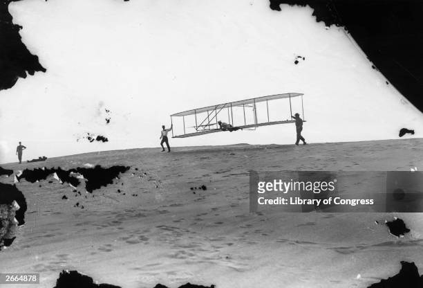 Orville and Wilbur Wright testing their No 3 glider at Kill Devil Hills, near Kitty Hawk, North Carolina.