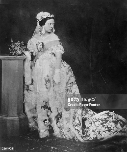 One of the first photographs for which Queen Victoria ever posed. Her ornate gown is embroidered with flowers and edged with lace.