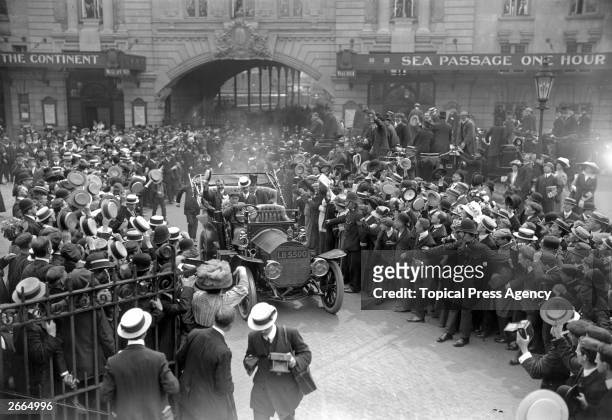 Crowds cheer French aviation pioneer Louis Bleriot at Victoria station, London, after his historic Channel flight. Seated next to Bleriot is the 1st...