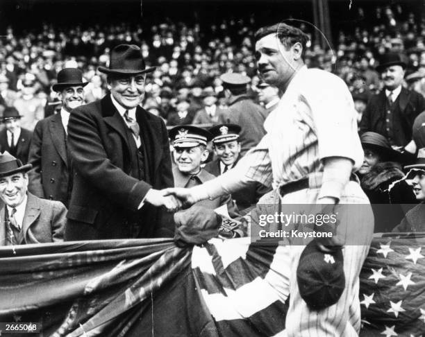 Great all-round baseball player, Babe Ruth shakes hands with the 29th President of the USA, Warren Harding. After the handshake Babe Ruth hit a home...