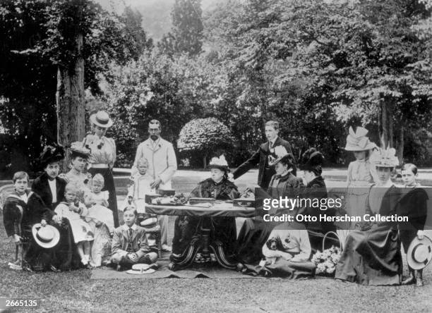 Queen Victoria surrounded by members of the royal family at Osborne House on the Isle of Wight. From left to right, Prince Leopold of Battenberg ,...