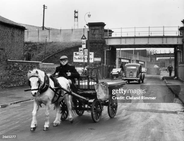 Rag and bone man Frank Gironella with his pony Titch who pulls an empty cart along a road near the Millwall canal, London.