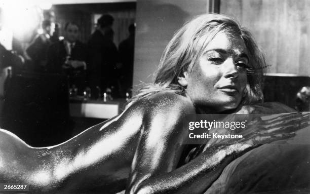 English actress Shirley Eaton covered in gold in the James Bond film 'Goldfinger', directed by Guy Hamilton and starring Sean Connery.