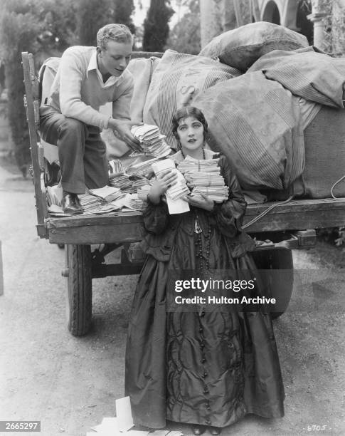 Screen actress and circus performer Renee Adoree receiving her fan mail.