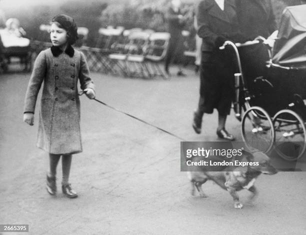 Princess Elizabeth exercising one of her Corgi dogs in London's Hyde Park.