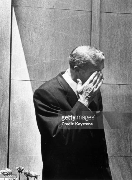 American baseball player Joe DiMaggio wipes a tear from his eye after bursting into tears at the funeral of Marilyn Monroe in Westwood Memorial Park,...