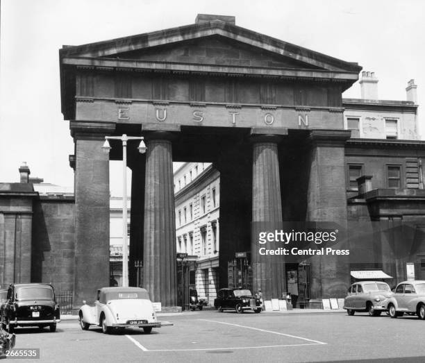 Cars parked in front of the doric arch at Euston station, London which is to be pulled down when the main line and underground station is rebuilt.